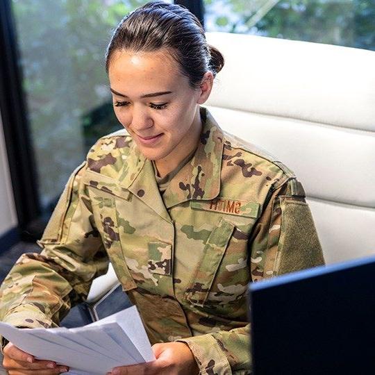 Man in an army uniform sitting at a desk using Eclypt technology to safeguard data on his laptop